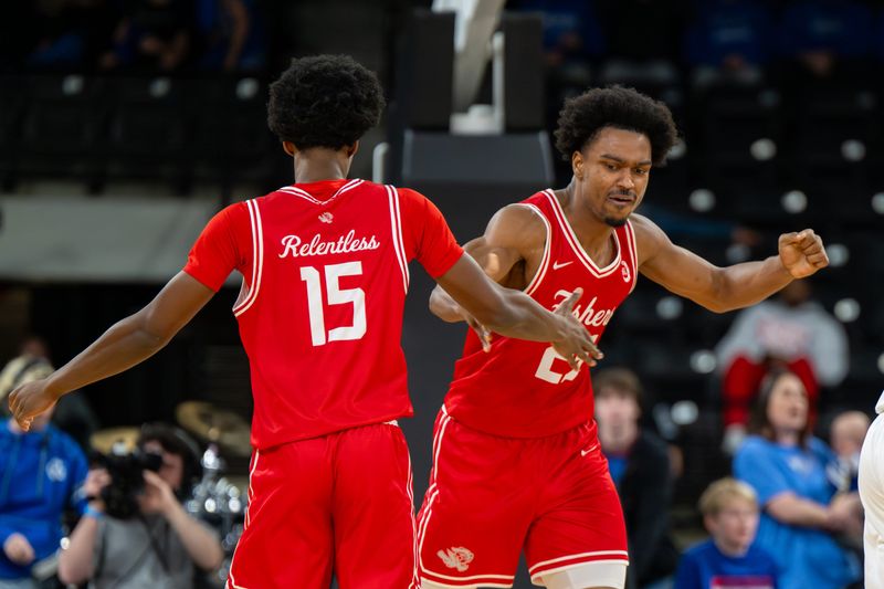 Fishers High School senior Kai McGrew (25) reacts with teammate junior Levi Walker (15) during the second half of a Mudsock Rivalry basketball game against Hamilton Southeastern High School, Friday, Dec. 19, 2025, at Fishers Event Center. Fishers High School won 68-61.