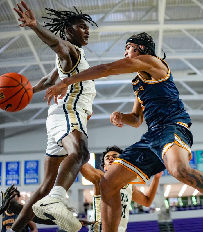 Wheeler Wildcats guard Kevin Savage III (2) passes the ball as Principia Panthers forward Ron Henry (32) tries to deflect it during the third quarter of a City of Palms Classic quarterfinal game at Suncoast Credit Union Arena in Fort Myers, Fla., on Saturday, Dec. 20, 2025.