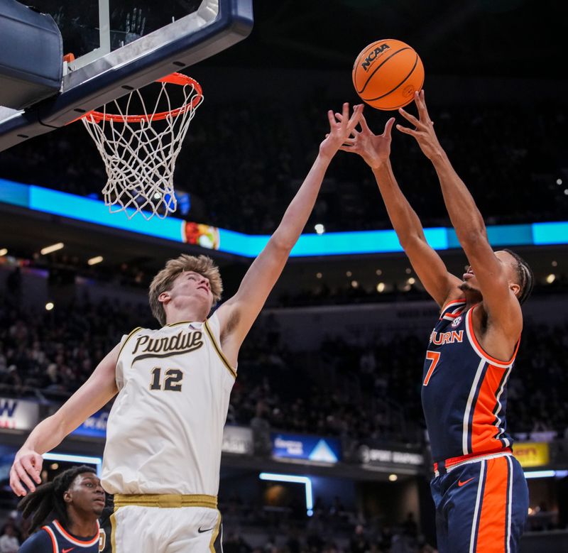 Purdue Boilermakers center Daniel Jacobsen (12) and Auburn Tigers guard Keyshawn Hall (7) go for the ball Saturday, Dec. 20, 2025, during a 2025 Indy Classic game between the Purdue Boilermakers and the Auburn Tigers at Gainbridge Fieldhouse in Indianapolis.