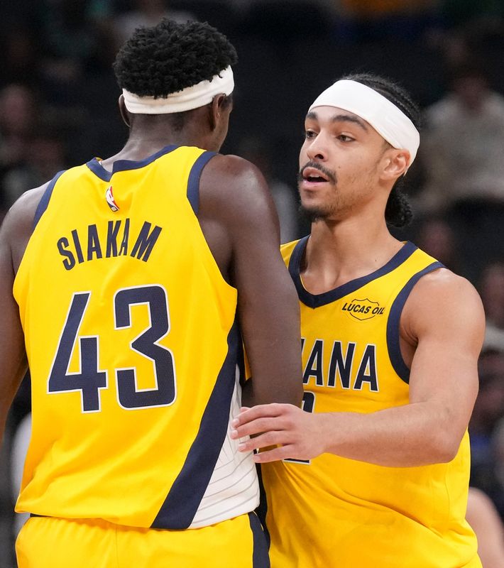 Indiana Pacers forward Pascal Siakam (43) greets Indiana Pacers guard Andrew Nembhard (2) during a timeout in the first half of a game against the Boston Celtics on Friday, Dec. 26, 2025, at Gainbridge Fieldhouse in Indianapolis.