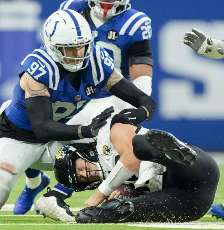 Jacksonville Jaguars quarterback Trevor Lawrence (16) is sacked by Indianapolis Colts defensive end Laiatu Latu (97) on Sunday, Dec. 28, 2025, during a game at Lucas Oil Stadium in Indianapolis.