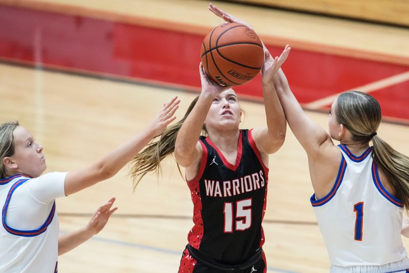 North Knox guard Caroline Yenne (15) goes up for a basket against Silver Creek Dragons guard Kate Campbell (4) and Silver Creek Dragons guard Emma Schoen (1) on Tuesday, Dec. 30, 2025, during the Carol Tumey Tournament at Center Grove in Greenwood.