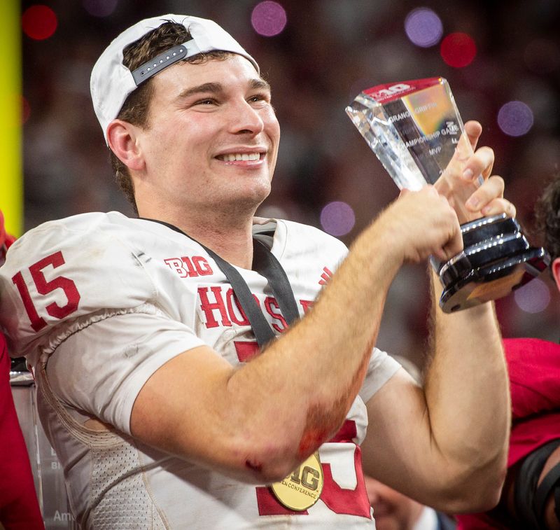 Indiana's Fernando Mendoza (15) holds the MVP trophy after the Indiana versus Ohio State Big Ten Championship football game at Lucas Oil Stadium on Saturday, Dec. 6, 2025.