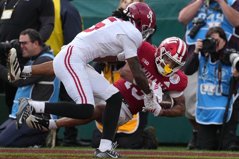 Jan 1, 2026; Pasadena, CA, USA; Indiana Hoosiers wide receiver Elijah Sarratt (13) scores a touchdown against Alabama Crimson Tide defensive back Dijon Lee Jr. (5) in the second half of the 2026 Rose Bowl and quarterfinal game of the College Football Playoff at Rose Bowl Stadium. Mandatory Credit: Kirby Lee-Imagn Images
