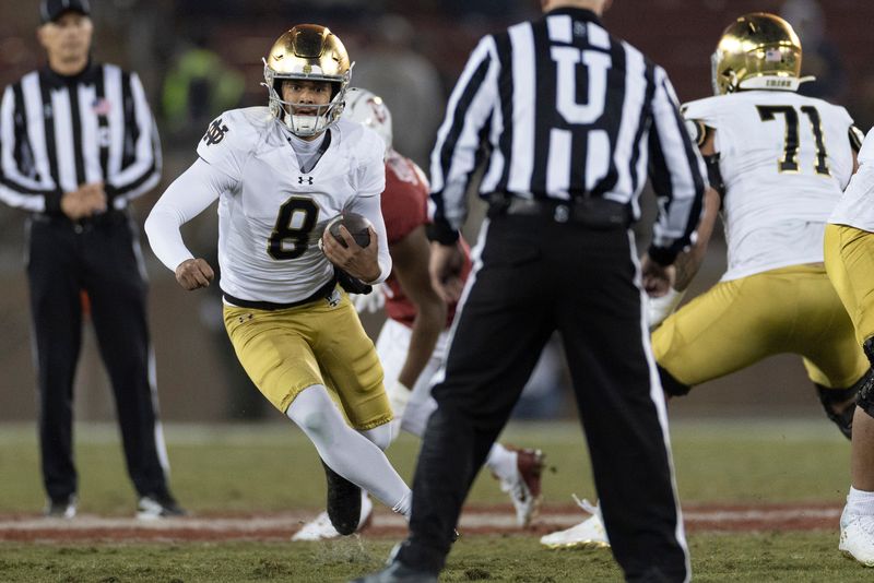 Nov 29, 2025; Stanford, California, USA; Notre Dame Fighting Irish quarterback Kenny Minchey (8) runs with the football during the fourth quarter against the Stanford Cardinal at Stanford Stadium. Mandatory Credit: Stan Szeto-Imagn Images