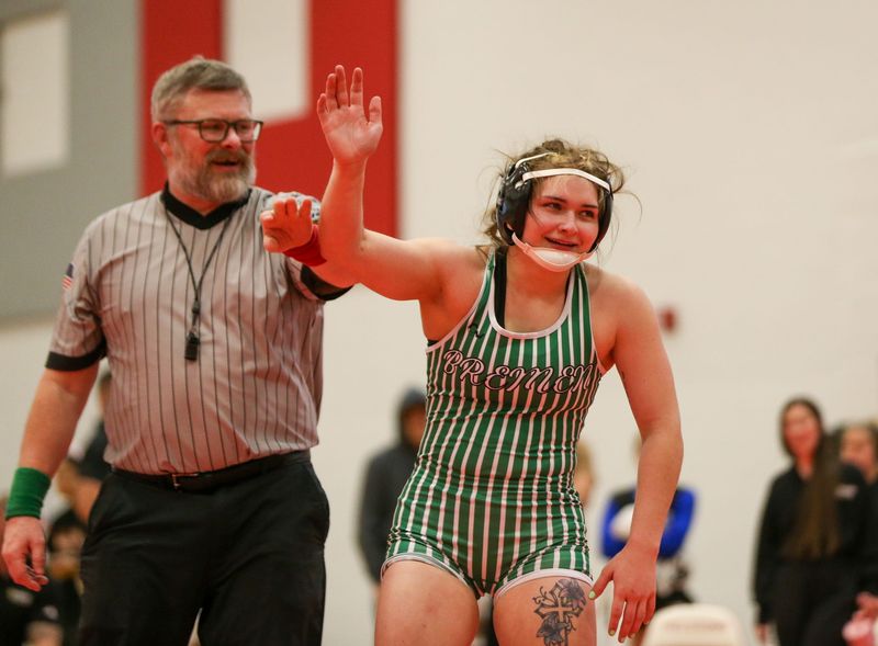 Bremen senior Makenzie Shumaker smiles as she gets her hand raised after an IHSAA girls wrestling sectional championship match at Lincoln Junior High School in Plymouth Friday, January 2.