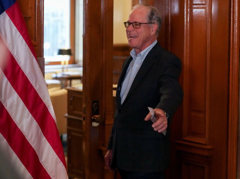 Indiana Gov. Mike Braun waves as he enters his office before lawmakers return for the 2026 legislative session Monday, Jan. 5, 2026, at the Indiana Statehouse in downtown Indianapolis.