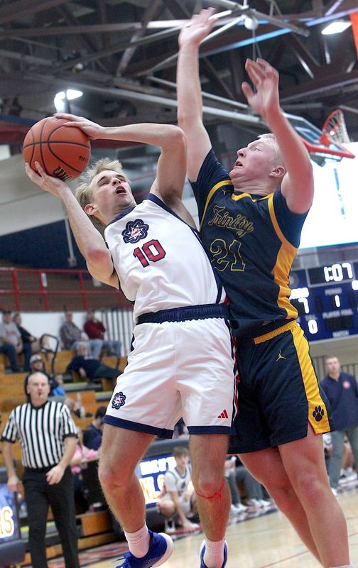 Bedford North Lawrence's Easton Moore (10) is fouled by Trinity Lutheran's Bode Brooks (21).