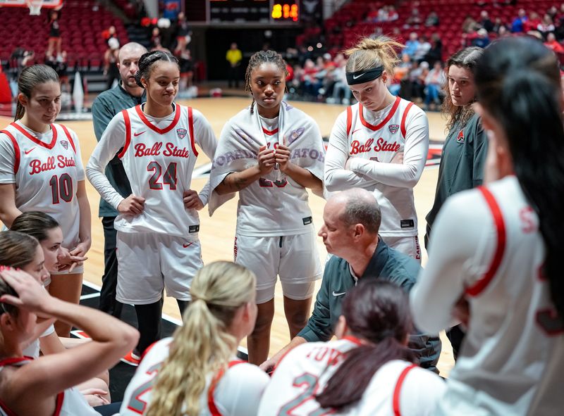 The Ball State team huddles around coach Brady Sallee in a timeout during a women's basketball game against Eastern Michigan Saturday, Dec. 20, 2025, at Worthen Arena in Muncie.
