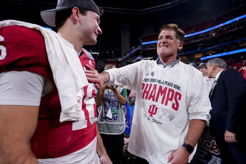 Mark Cuban talks with Indiana Hoosiers quarterback Alberto Mendoza (16) on Friday, Jan. 9, 2026, after the Indiana Hoosiers defeated the Oregon Ducks in the Peach Bowl and semifinal game of the College Football Playoff at Mercedes-Benz Stadium in Atlanta.