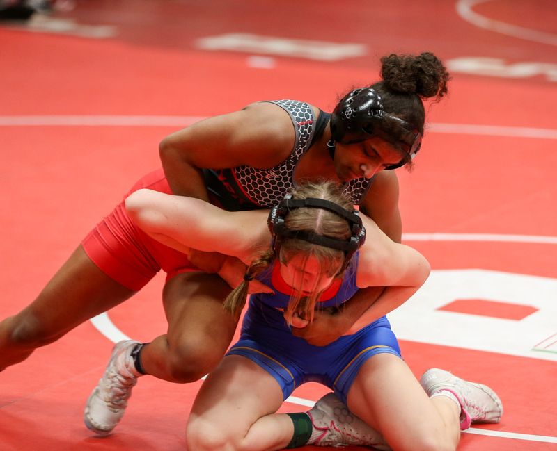 NorthWood senior Naima Ghaffar grapples against Highland freshman Samantha Ralph in an IHSAA girls wrestling regional quarterfinal match Saturday, January 10, 2026, at Plymouth High School.