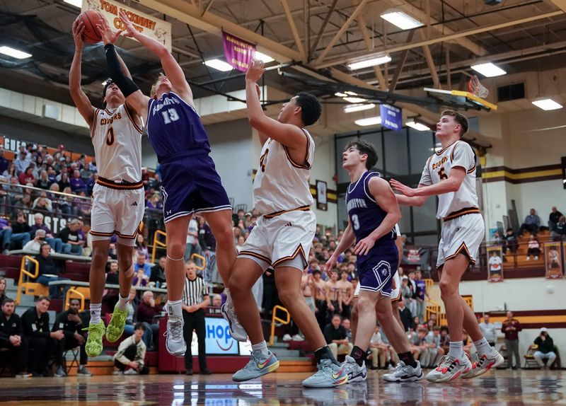 Bloomington North’s Derrick Cross Jr. (0) and Bloomington South’s Rylan Stikeleather (13) go for a rebound during the North-South boys’ basketball game at North on Monday, Jan. 12, 2026.