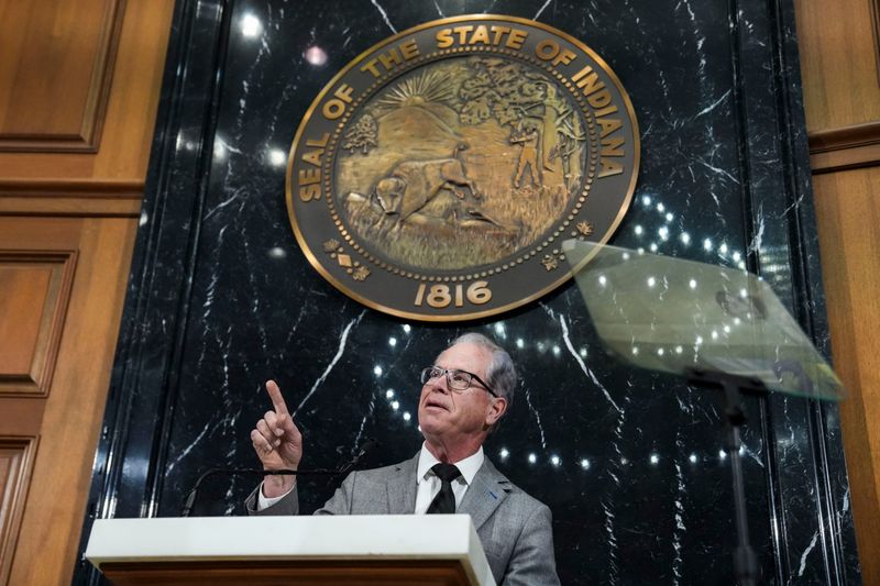 Gov. Mike Braun points up Wednesday, Jan. 14, 2026, during his second State of the State address to the General Assembly at the Indiana State Capitol in Indianapolis.