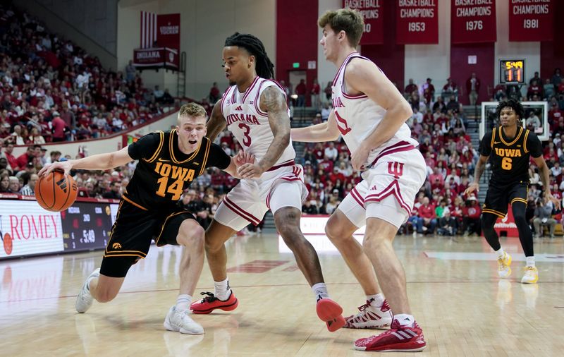 Jan 17, 2026; Bloomington, Indiana, USA; Iowa Hawkeyes guard Bennett Stirtz (14) dribbles the ball against Indiana Hoosiers guard Lamar Wilkerson (3) during the first half at Simon Skjodt Assembly Hall. Mandatory Credit: Robert Goddin-Imagn Images