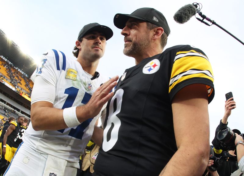 Nov 2, 2025; Pittsburgh, Pennsylvania, USA; Pittsburgh Steelers quarterback Aaron Rodgers (8) and Indianapolis Colts quarterback Daniel Jones (17) shake hands after the game at Acrisure Stadium. Mandatory Credit: Charles LeClaire-Imagn Images
