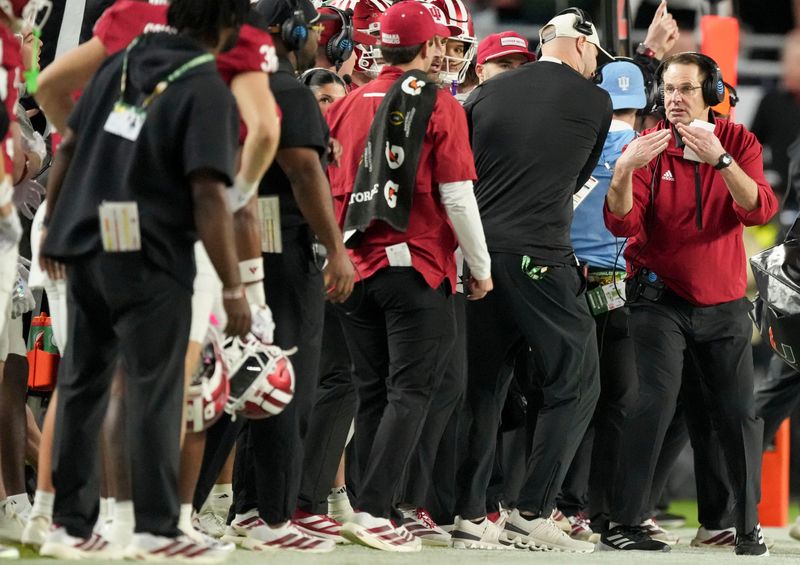 Indiana Hoosiers head coach Curt Cignetti looks to call a timeout Monday, Jan. 19, 2026, during the College Football Playoff National Championship college football game against the Miami (FL) Hurricanes at Hard Rock Stadium in Miami Gardens.