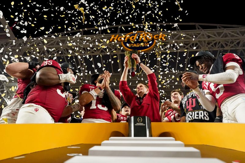 Indiana Hoosiers head coach Curt Cignetti hoists the championship trophy Monday, Jan. 19, 2026, after defeating the Miami (FL) Hurricanes in the College Football Playoff National Championship college football game at Hard Rock Stadium in Miami Gardens.
