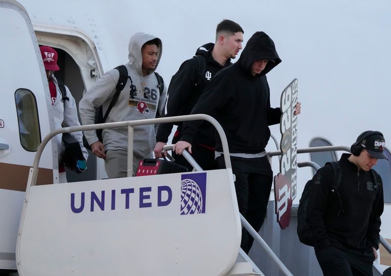 Indiana players walk off an airplane as they return home after beating Miami in the College Football Playoff national championship game on Tuesday, Jan. 20, 2026, in Indianapolis.