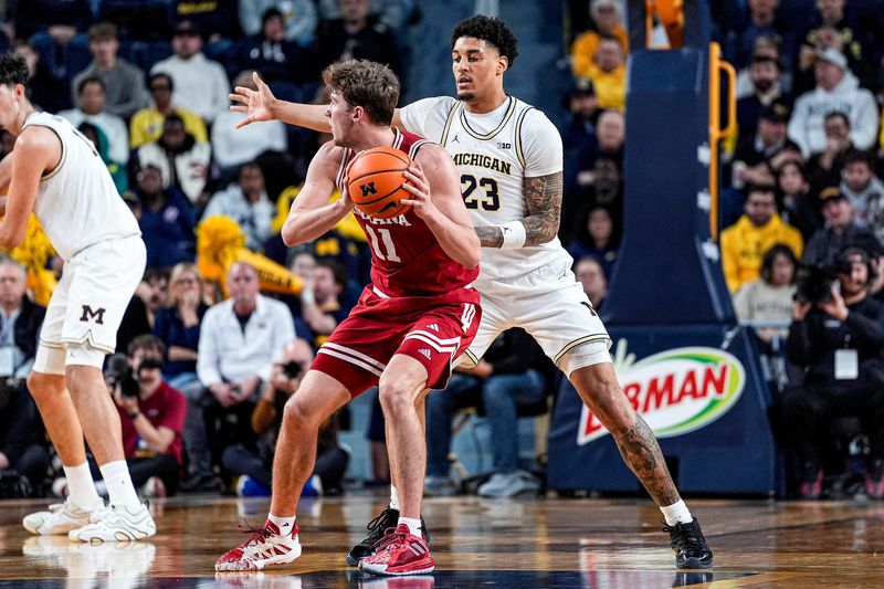 Michigan forward Yaxel Lendeborg (23) defends Indiana forward Trent Sisley (11) during the first half at Crisler Center in Ann Arbor on Tuesday, Jan. 20, 2026.
