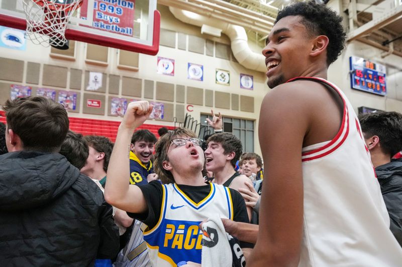 Plainfield Quakers Noah Smith (2) celebrates with the student section Tuesday, Jan. 20, 2026, after a game between the Plainfield Quakers and the Lawrence North Wildcats at Plainfield High School. The Plainfield Quakers defeated the Lawrence North Wildcats, 65-62.