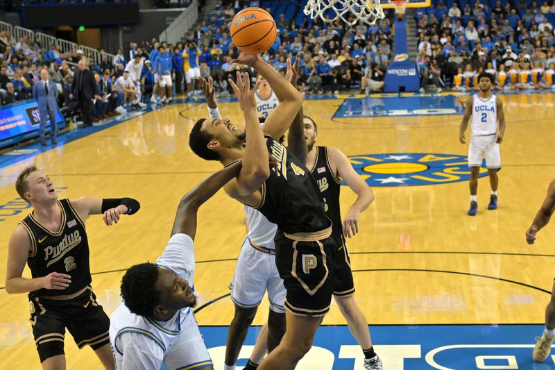 Jan 20, 2026; Los Angeles, California, USA; Purdue Boilermakers forward Trey Kaufman-Renn (4), UCLA Bruins forward Xavier Booker (1) and guard Eric Dailey Jr. (3) battle for a rebound in the first half at Pauley Pavilion presented by Wescom Financial. Mandatory Credit: Jayne Kamin-Oncea-Imagn Images