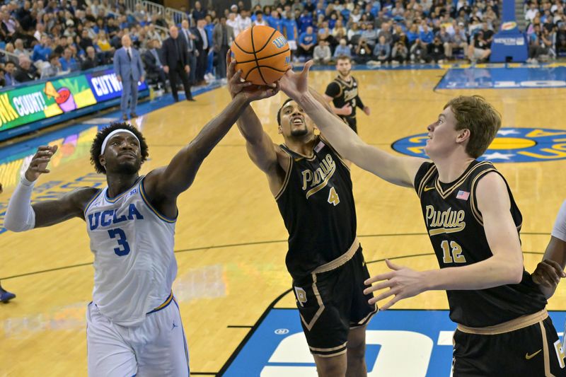 UCLA Bruins guard Eric Dailey Jr. (3), Purdue Boilermakers forward Trey Kaufman-Renn (4) and center Daniel Jacobsen (12) reach for a rebound in the second half at Pauley Pavilion presented by Wescom Financial.