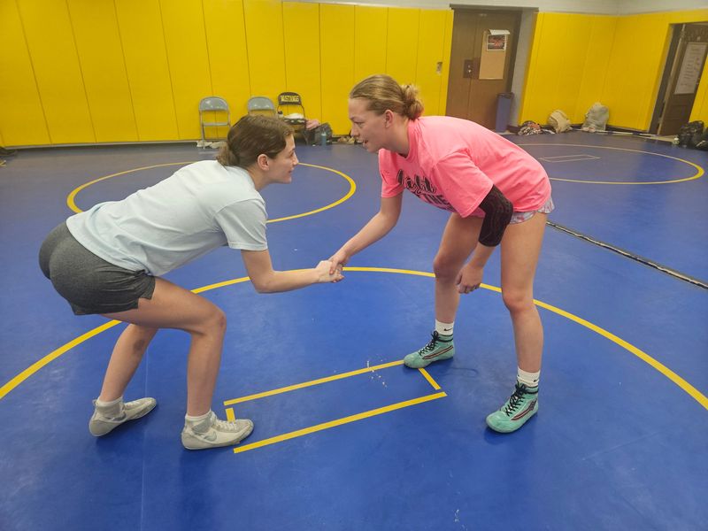 Fountain Central wrestlers Riley Deel (left) and Jayden Martin (right) shake hands before performing a 'first to seven' drill on Wednesday, Jan. 14, 2026 in Veedersburg, Indiana.
