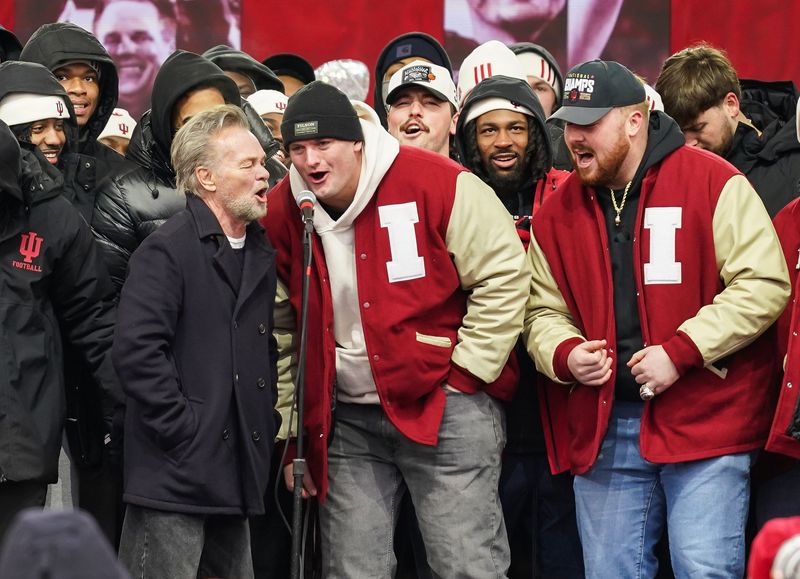 Indiana Hoosiers offensive lineman Pat Coogan (78) sings 'Hurt So Good' with John Mellencamp on Saturday, Jan. 24, 2026, during the Indiana Football College Football Playoff National Championship celebration and parade at Memorial Stadium in Bloomington.
