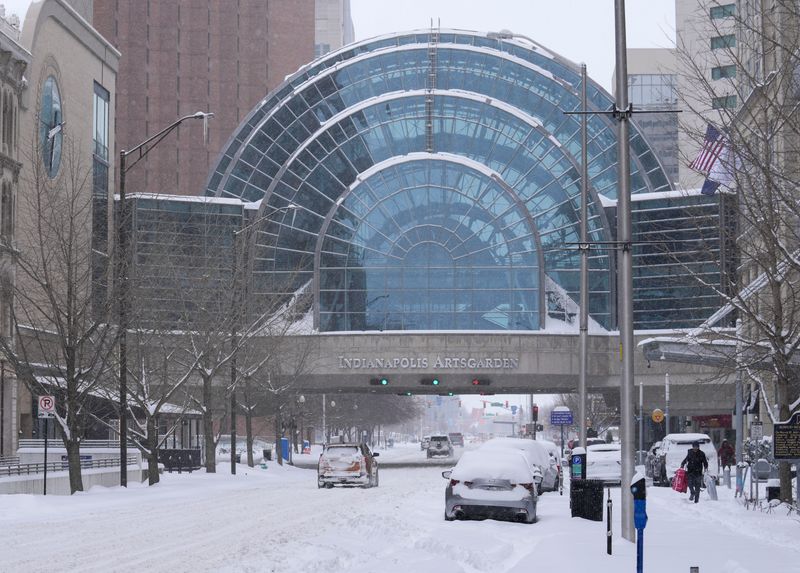 Snow falls Sunday, Jan. 25, 2026, in downtown Indianapolis.