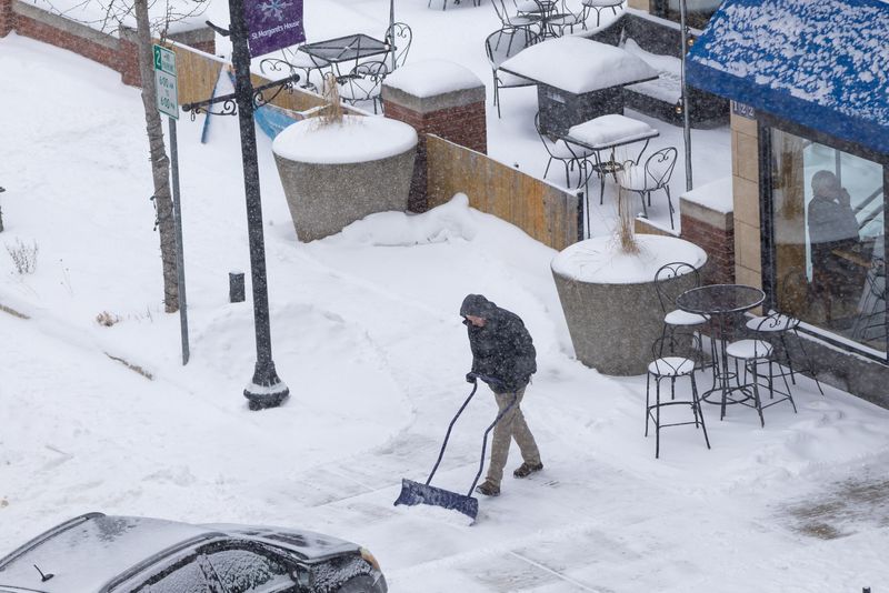 A person shovels snow Jan. 25, 2026, in downtown South Bend.