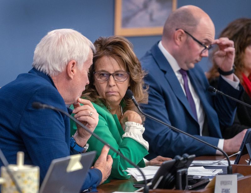Rep. Bob Behning, left, talks with Rep. Michelle Davis during the House Education Committee hearing discussing House Bill 1086 Tuesday, Jan. 27, 2026 at the Indiana Statehouse. The bill addresses displaying the Ten Commandments in classrooms and school libraries. Rep. Davis authored the bill.