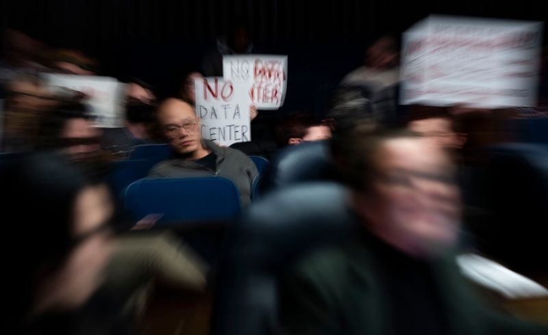 Residents hold signs Wednesday, Jan. 28, 2026, during an Indianapolis City-Council meeting to discuss regulations and community impact of a purposed data center at the City-County Building in downtown Indianapolis.