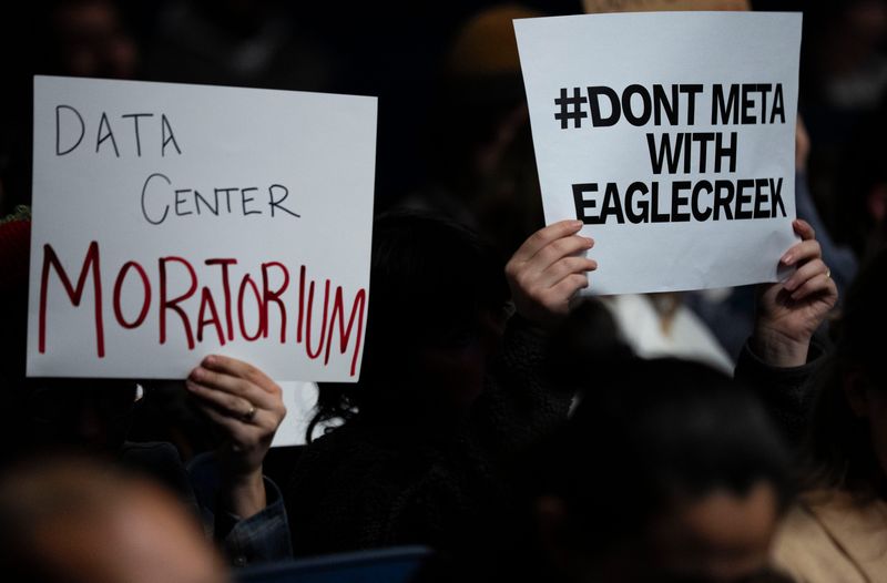 Residents hold signs Wednesday, Jan. 28, 2026, during an Indianapolis City-Council meeting to discuss regulations and community impact of a purposed data center at the City-County Building in downtown Indianapolis.
