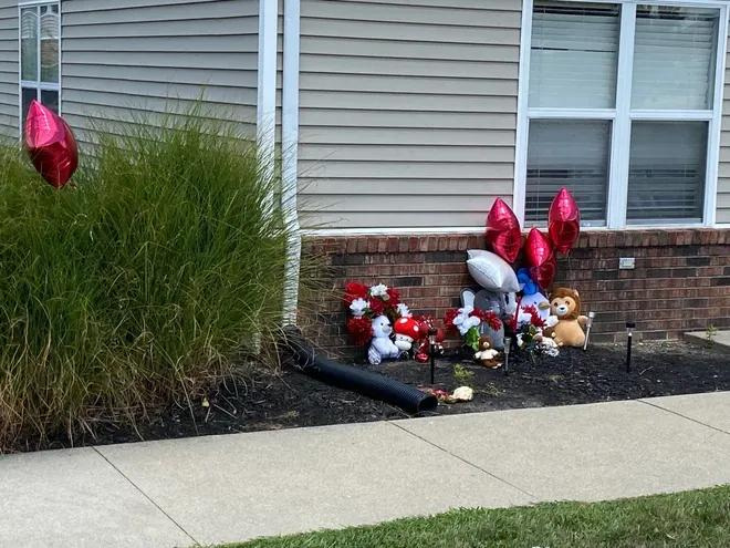 Flowers, balloons and stuffed animals on Aug. 20, 2024 marked the location, outside the clubhouse at Latitude apartments in northeast Muncie, where a 15-year-old local youth was fatally shot on the evening of Aug. 14.
