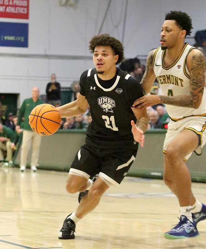 UMBC's Cougar Downing drives to the basket during the Retrievers 64-55 loss to Vermont on Thursday night at UVM's Patrick Gym.
