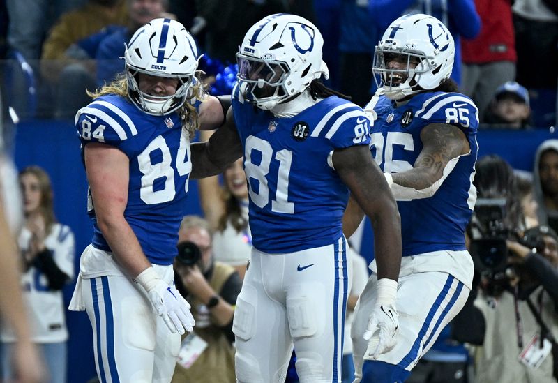 Nov 30, 2025; Indianapolis, Indiana, USA; Indianapolis Colts tight end Tyler Warren (84) celebrates with tight end Mo Alie-Cox (81) and tight end Drew Ogletree (85) after a touchdown during the second half against the Houston Texans at Lucas Oil Stadium. Mandatory Credit: Robert Goddin-Imagn Images
