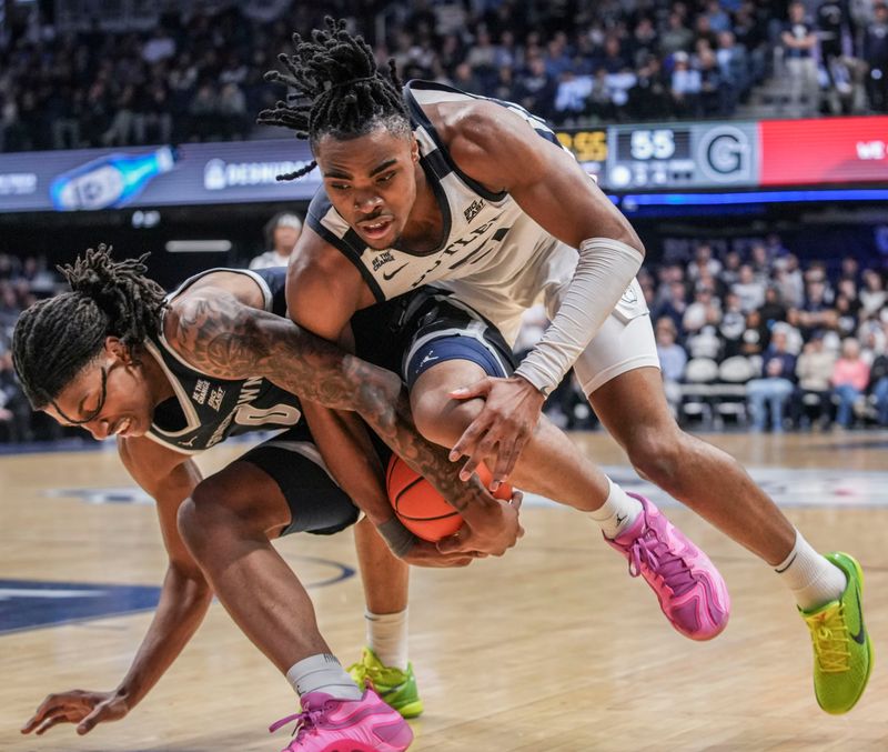 Georgetown Hoyas forward Jayden Fort (0) and Butler Bulldogs forward Michael Ajayi (5) go for the ball Saturday, Jan. 31, 2026, during a basketball game at Hinkle Fieldhouse in Indianapolis. The Georgetown Hoyas defeated the Butler Bulldogs, 77-64.