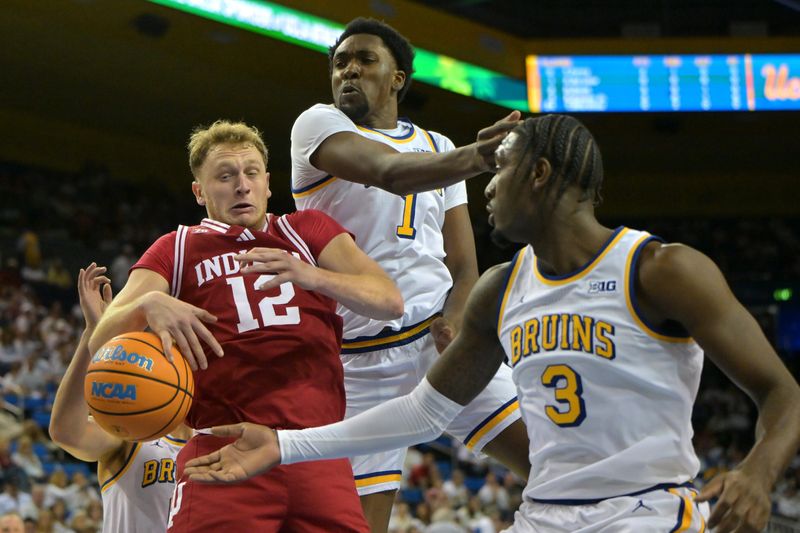 Jan 31, 2026; Los Angeles, California, USA; Indiana Hoosiers forward Tucker DeVries (12) and UCLA Bruins forward Xavier Booker (1) and guard Eric Dailey Jr. (3) go for a rebound in the first half at Pauley Pavilion presented by Wescom Financial. Mandatory Credit: Jayne Kamin-Oncea-Imagn Images
