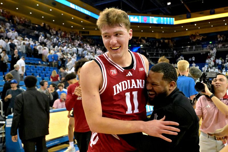 Jan 31, 2026; Los Angeles, California, USA; Indiana Hoosiers forward Trent Sisley (11) celebrates with assistand coach Rod Clark after defeating the UCLA Bruins in double overtime at Pauley Pavilion presented by Wescom Financial.