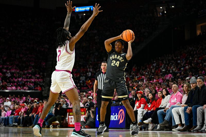 Feb 1, 2026; College Park, Maryland, USA; Purdue Boilermakers guard Gicarri Harris (24) looks to pass as Maryland Terrapins guard Andre Mills (7) defends during the first half at Xfinity Center. Mandatory Credit: Tommy Gilligan-Imagn Images