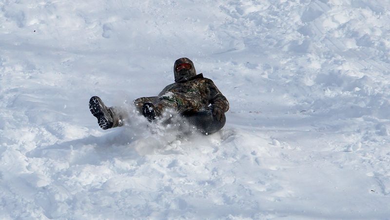 Gracie Simmerman kicks up some snow as she tubes at Otis Park on the afternoon of Friday, Jan. 28, 2026. The area of the 12th green has traditionally been the No. 1 sledding/tubing slope in Bedford.