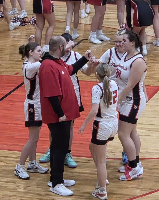 Eastern Greene girls basketball coach Jeremy Clark (in red) gathers his starting five before the tip off of their Class 2A Sectional 47 game at home vs. West Vigo on Tuesday, Feb. 3, 2026.