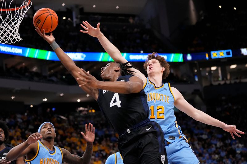 Feb 7, 2026; Milwaukee, Wisconsin, USA; Butler Bulldogs forward Efeosa Oliogu-Elabor (4) shoots beyond the reach of Marquette Golden Eagles forward Ben Gold (12) during the first half at Fiserv Forum. Mandatory Credit: Jeff Hanisch-Imagn Images