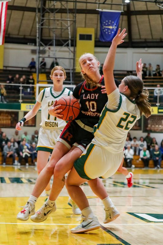 Rennselaer guard Courtney Mathew runs through Benton Central's McKenna Yadon during the IHSAA girl's sectional championship matchup between Benton Central and Rensselaer Central on Feb. 7, 2026 at Benton Central High School.