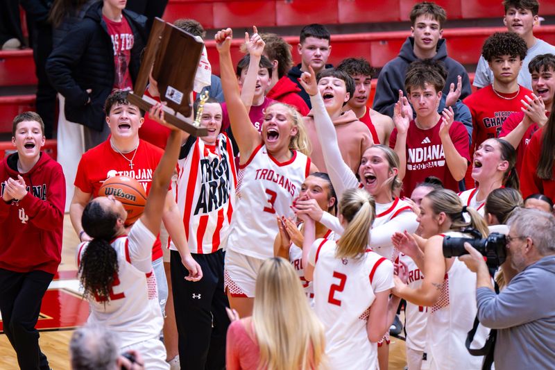Center Grove High School players celebrate after winning an IHSAA class 4A sectional championship game against Franklin Central High School, Saturday, Feb. 7, 2026, at Center Grove High School. Center Grove High School won 55-50.