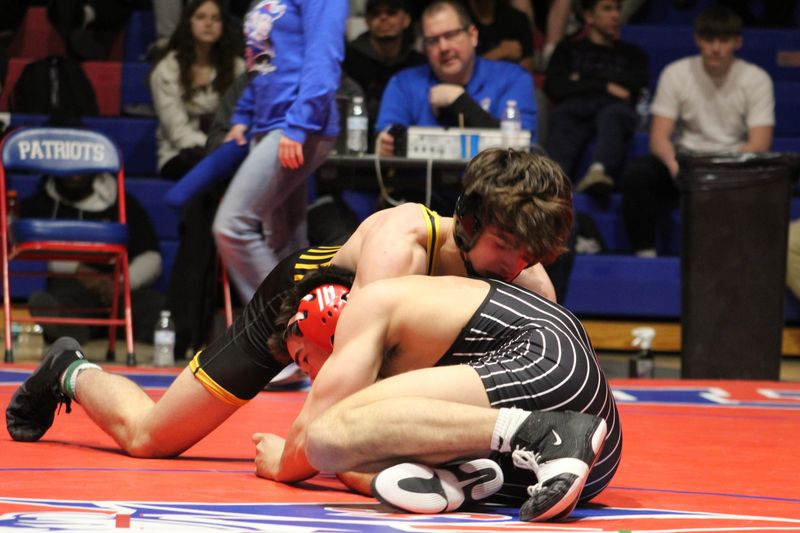 Cowan senior Jackson Bradley wrestles Adams Central senior Maverick Dubach in the 157-pound IHSAA regional title bout at Jay County High School on Saturday, Feb. 7, 2026.