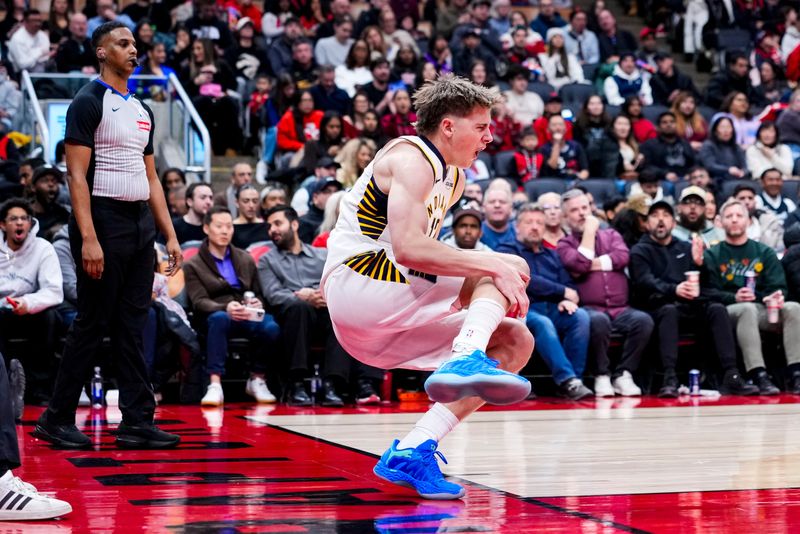 Feb 8, 2026; Toronto, Ontario, CAN; Indiana Pacers guard Johnny Furphy (12) reacts after injuring himself during the second half against the Toronto Raptors at Scotiabank Arena. Mandatory Credit: Kevin Sousa-Imagn Images
