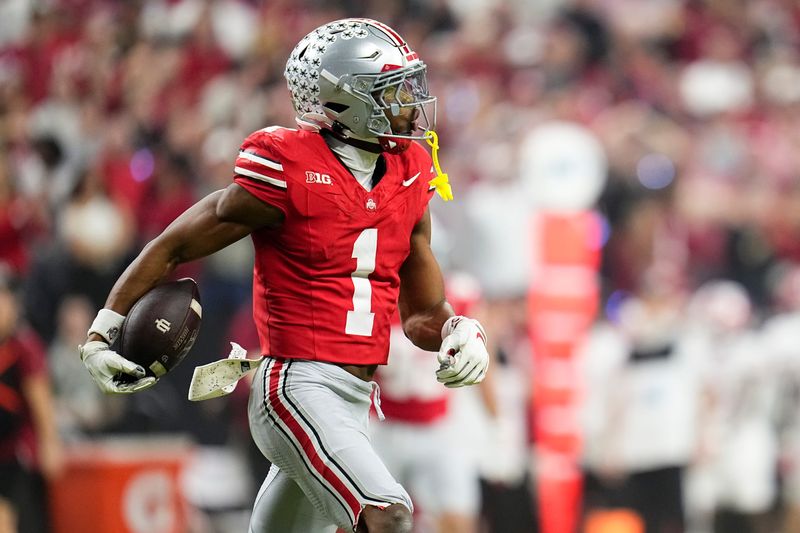Ohio State Buckeyes cornerback Davison Igbinosun (1) celebrates an interception during the first half of the Big Ten Conference championship game against the Indiana Hoosiers at Lucas Oil Stadium in Indianapolis on Dec. 6, 2025.