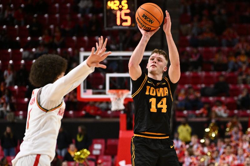Feb 11, 2026; College Park, Maryland, USA; Iowa Hawkeyes guard Bennett Stirtz (#14) shoots for three points in the first half against the Maryland Terrapins at Xfinity Center. Mandatory Credit: Jamie Sabau-Imagn Images