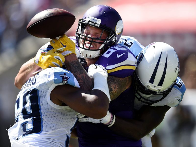 Tennessee Titans inside linebacker Wesley Woodyard (59) and strong safety Da'Norris Searcy (21) crush Minnesota Vikings tight end Kyle Rudolph (82) at Nissan Stadium in Nashville on Sept. 11, 2016. The Titans lost their home and season opener 25-16.